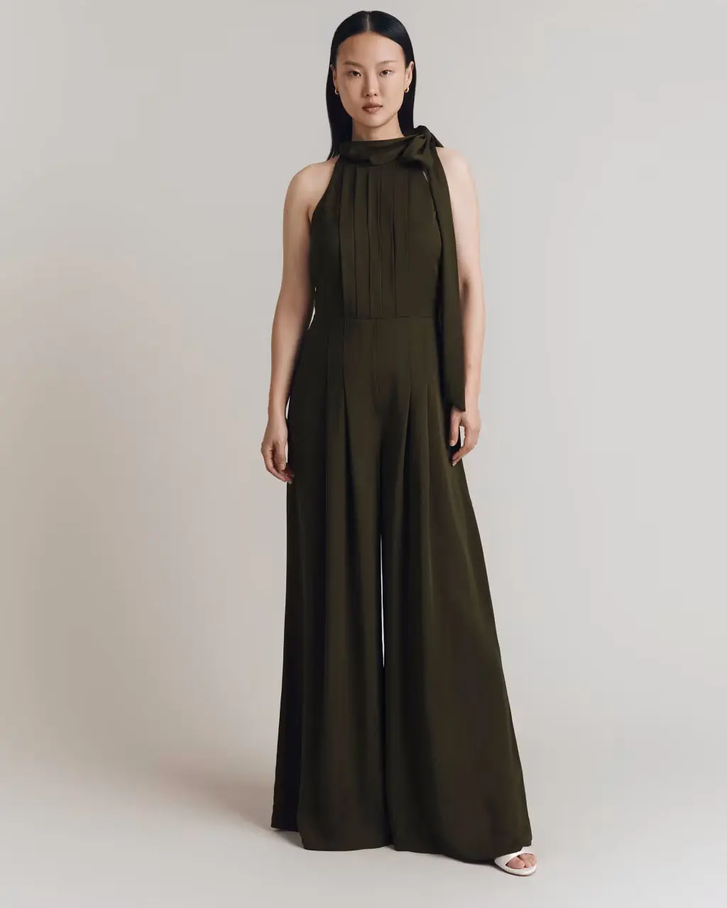 Woman wearing a green crepe jumpsuit at M&S