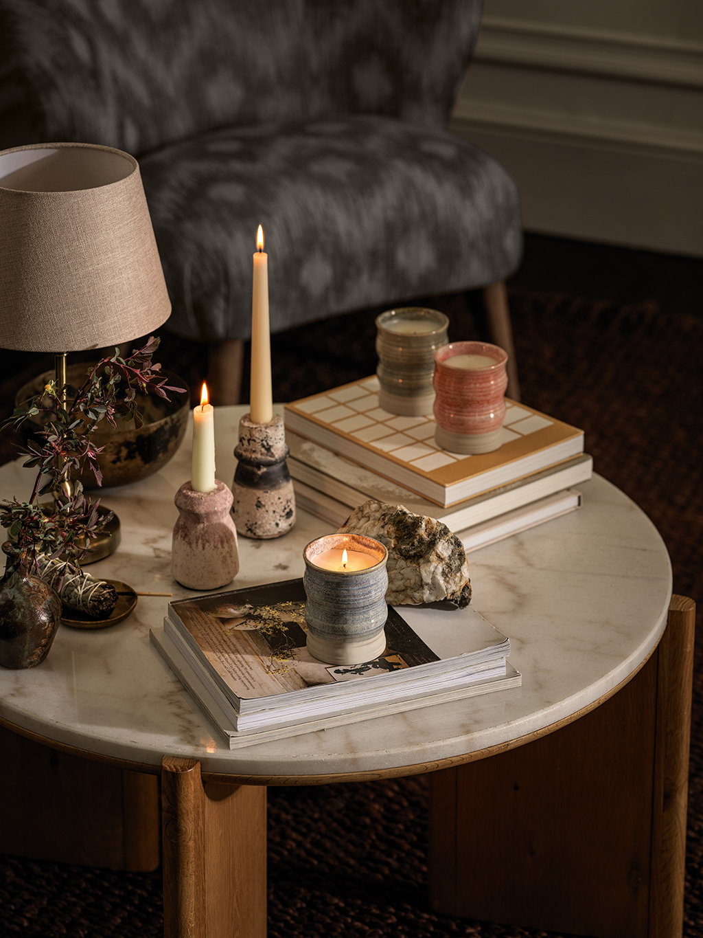 Assorted scented candles on a marble coffee table. Shop scented candles