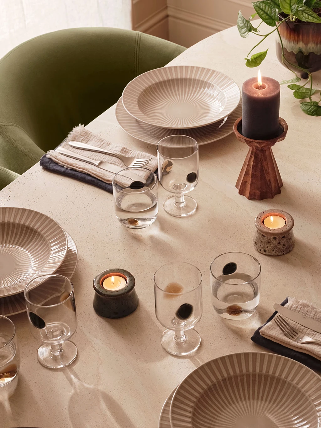 Assorted scented candles on a dinner table