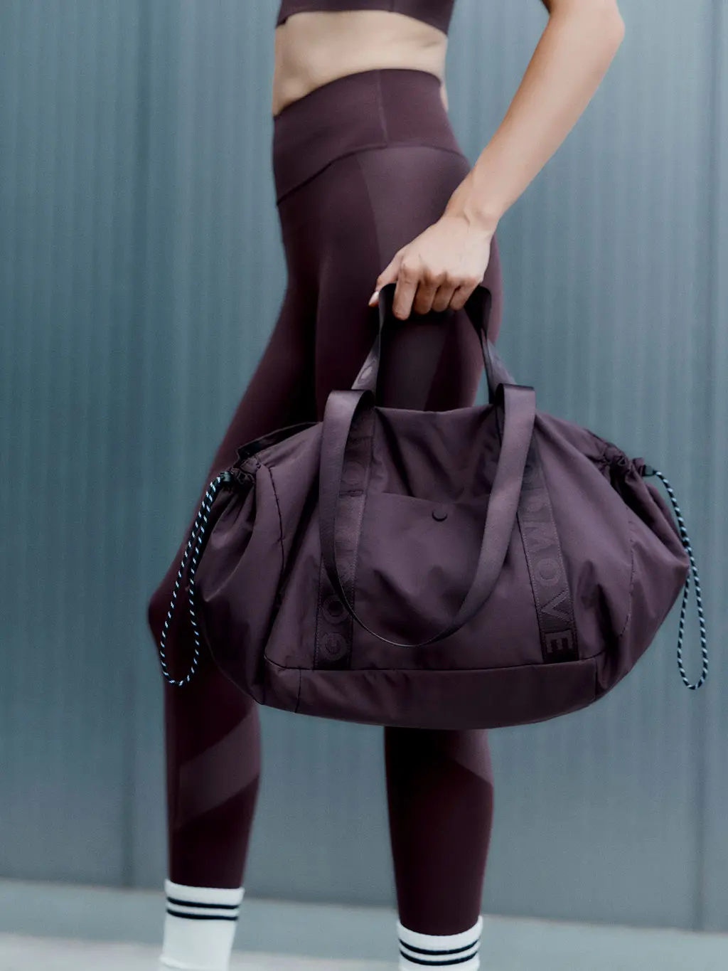 Woman holding gym bag
