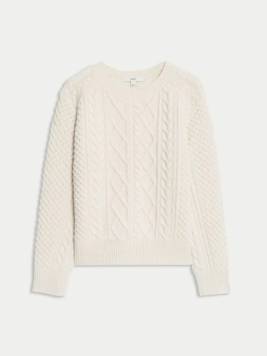 A cutout of a cream cable knit sweater by M&S