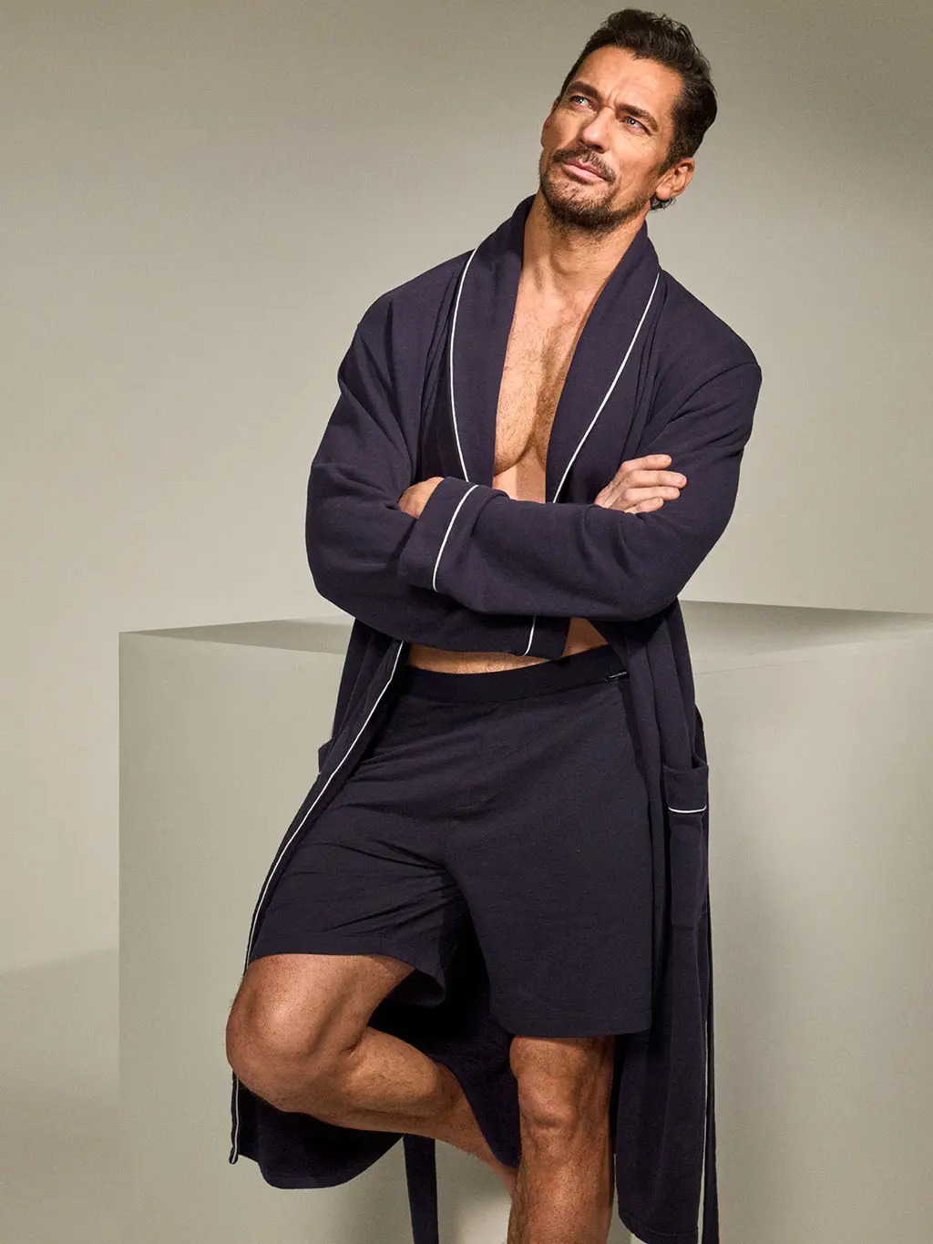 David Gandy wearing a navy Wellwear dressing gown and shorts