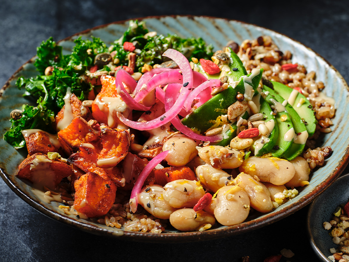 A buddha bowl with grains, vegetables and a tahini dressing. 