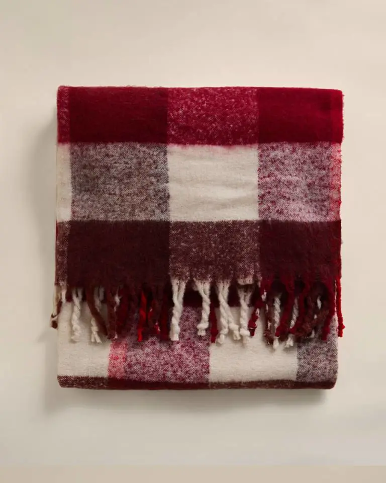 A red and cream faux mohair throw