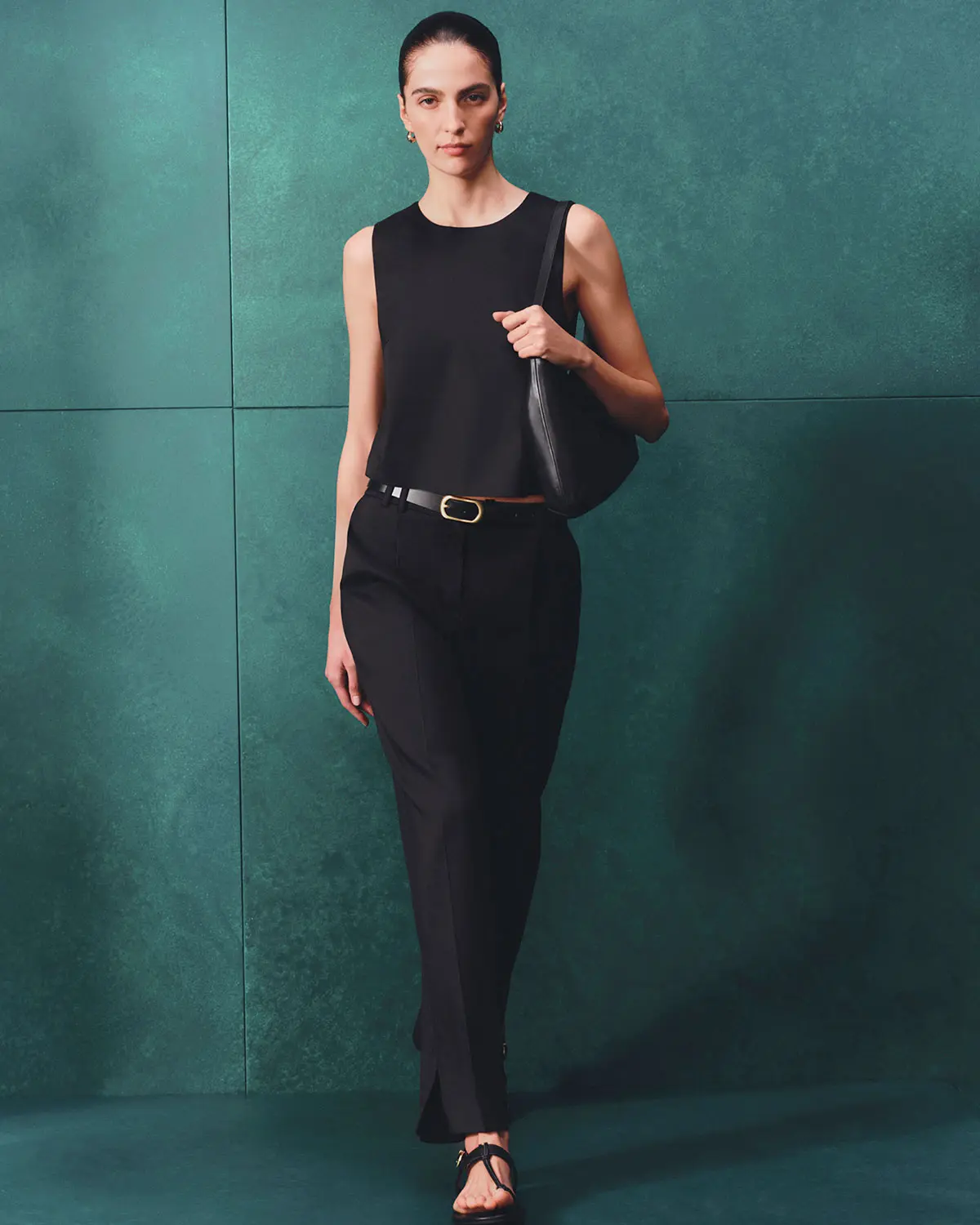 Woman wearing black trousers and top by Autograph