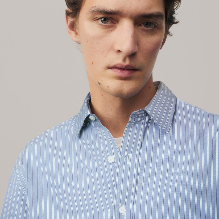 Man wearing blue stripped casual shirt