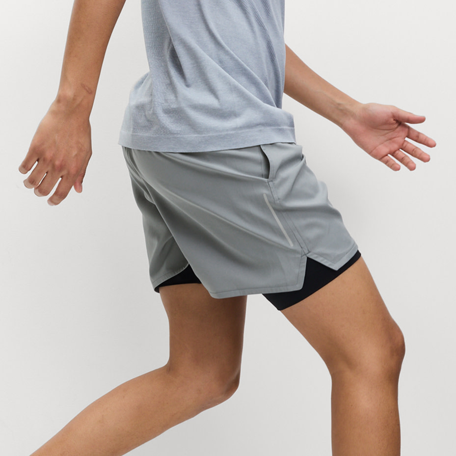 Man wearing grey sports T-shirt and grey shorts