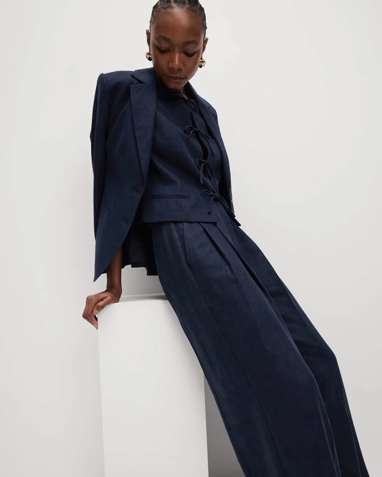 Woman wearing navy waistcoat, blazer and trousers