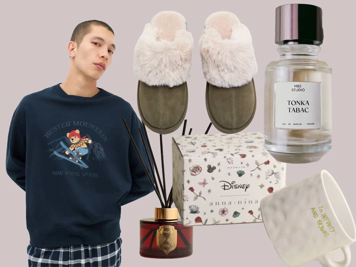 Slippers, bottle of perfume, mug, diffuser and man in navy jumper and pyjama bottoms