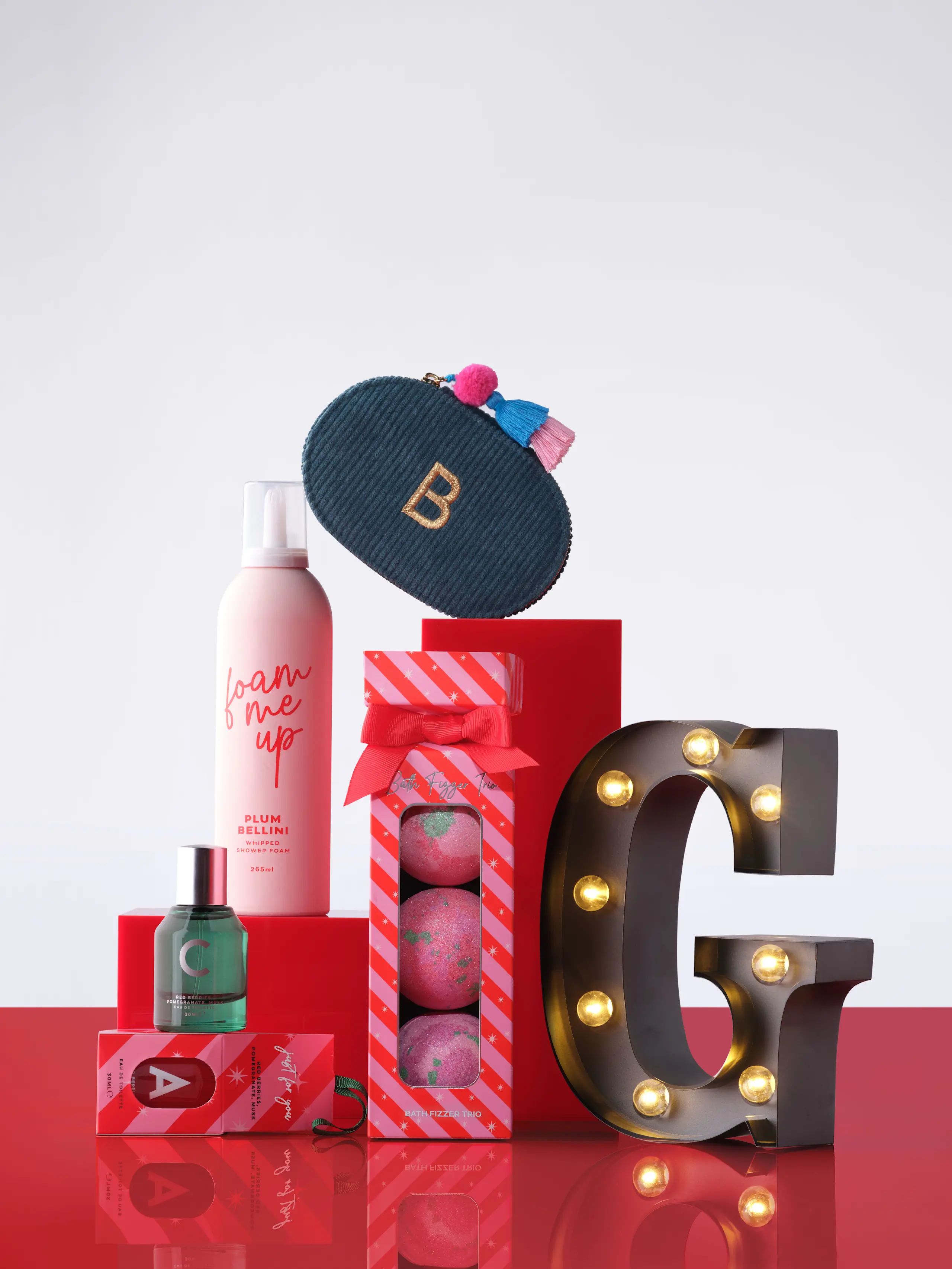 Image of beauty products, light up letter G and purse