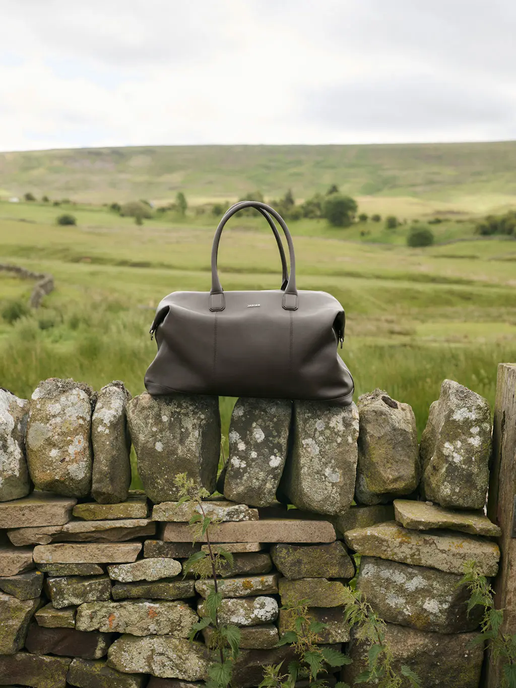 Jaeger leather bag on brick wall