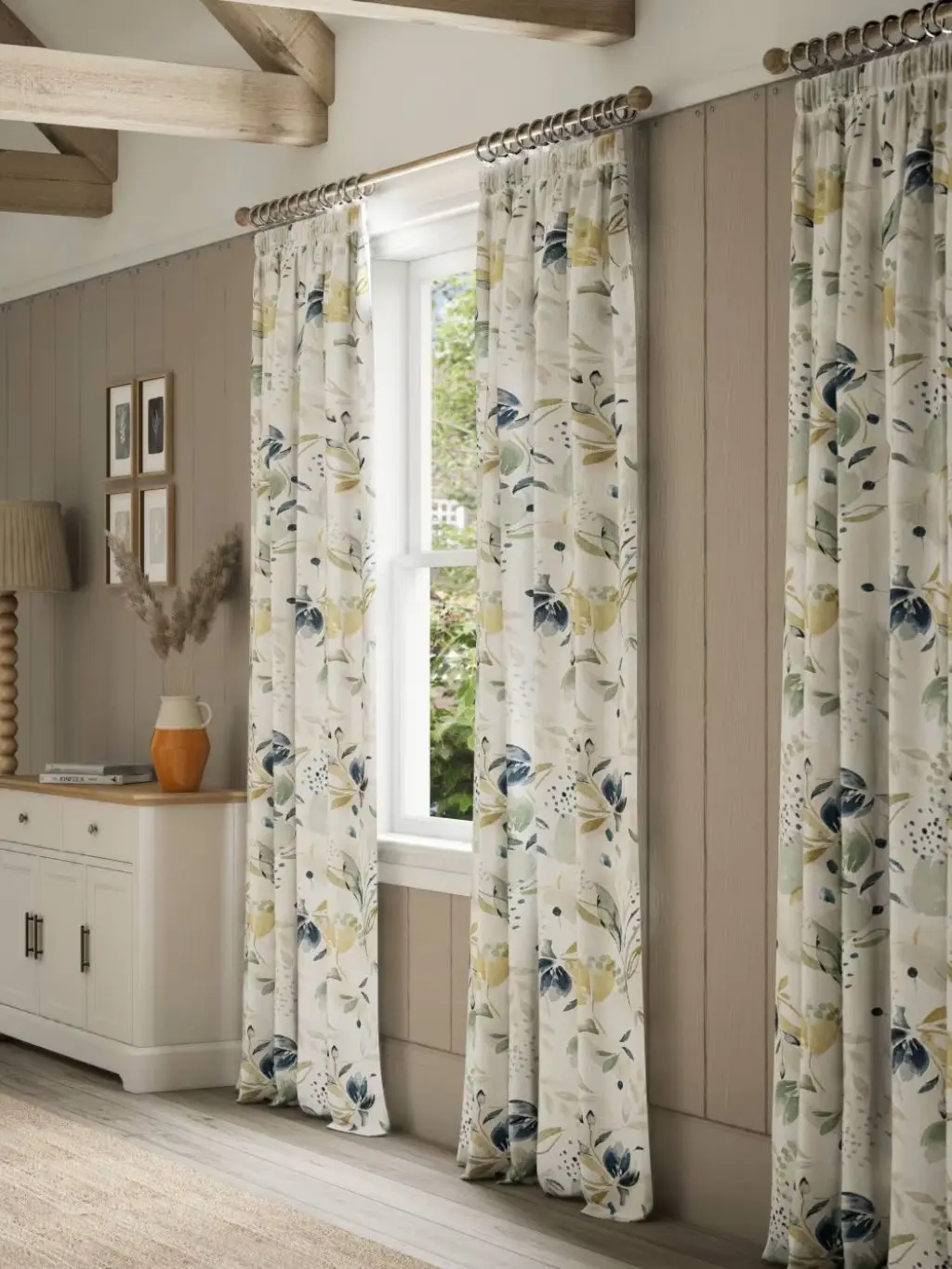 Patterned floral curtains hung up in a living room