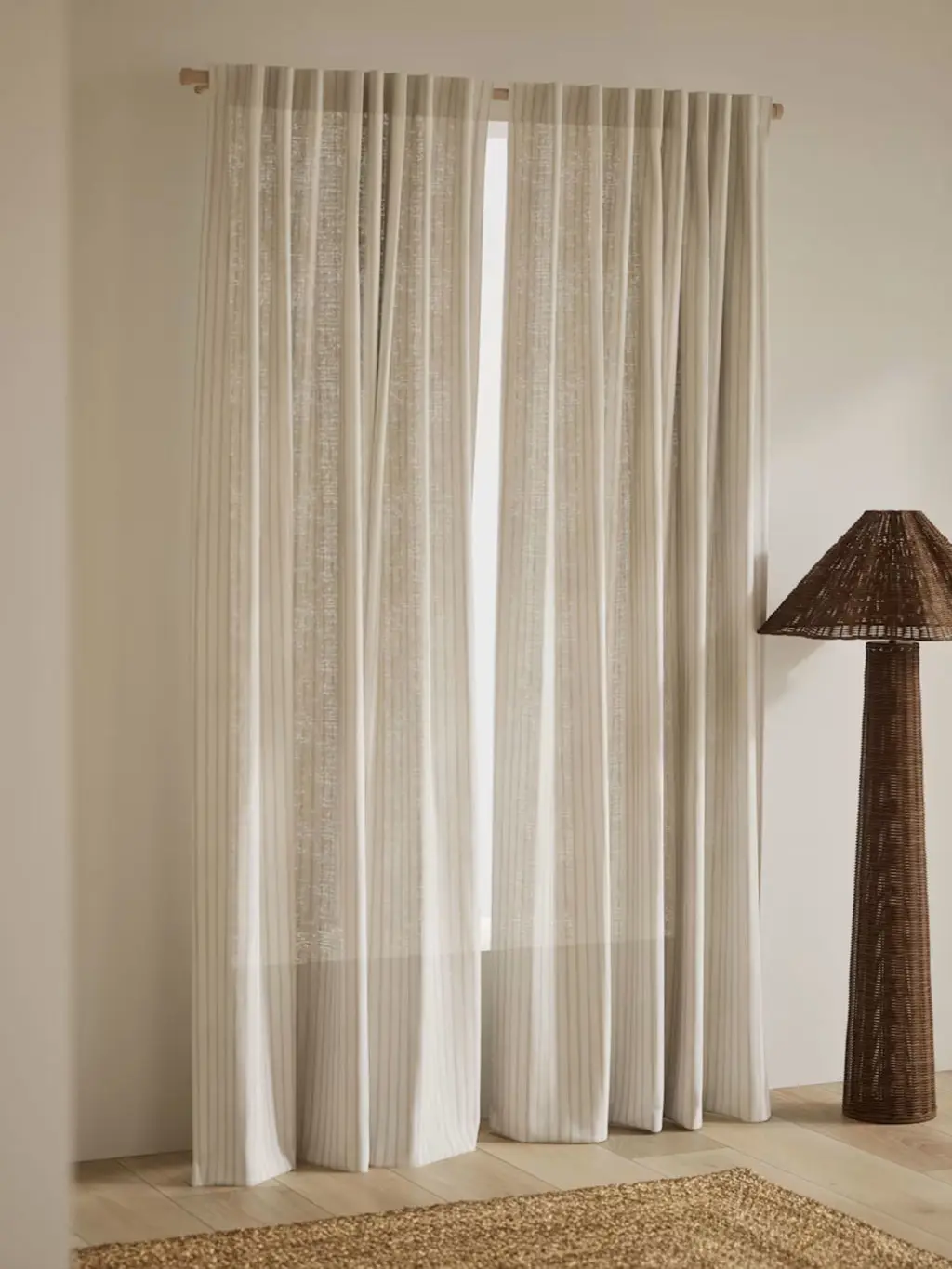 Neutral curtains with brown lamp
