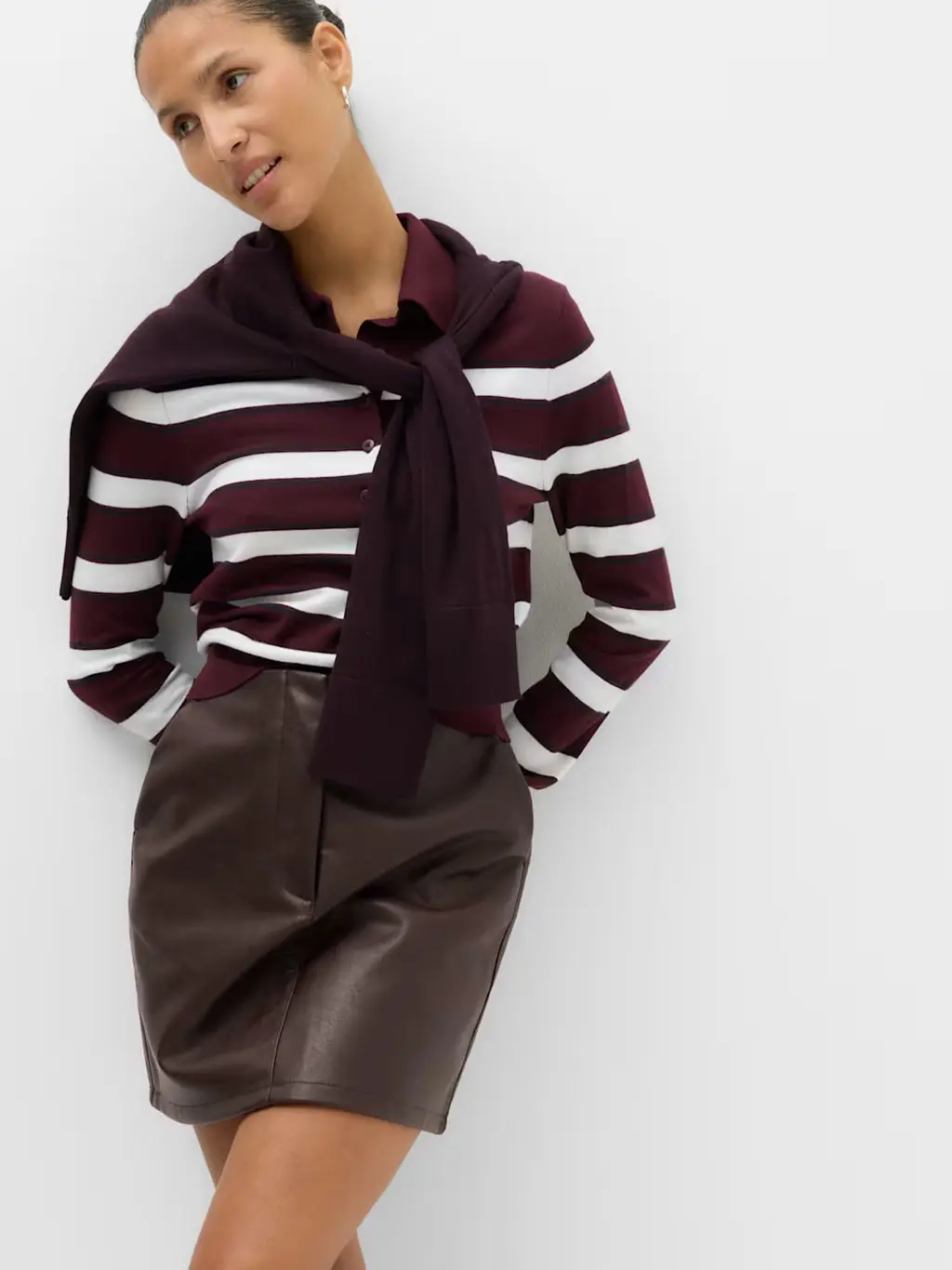 Woman in striped top and leather skirt