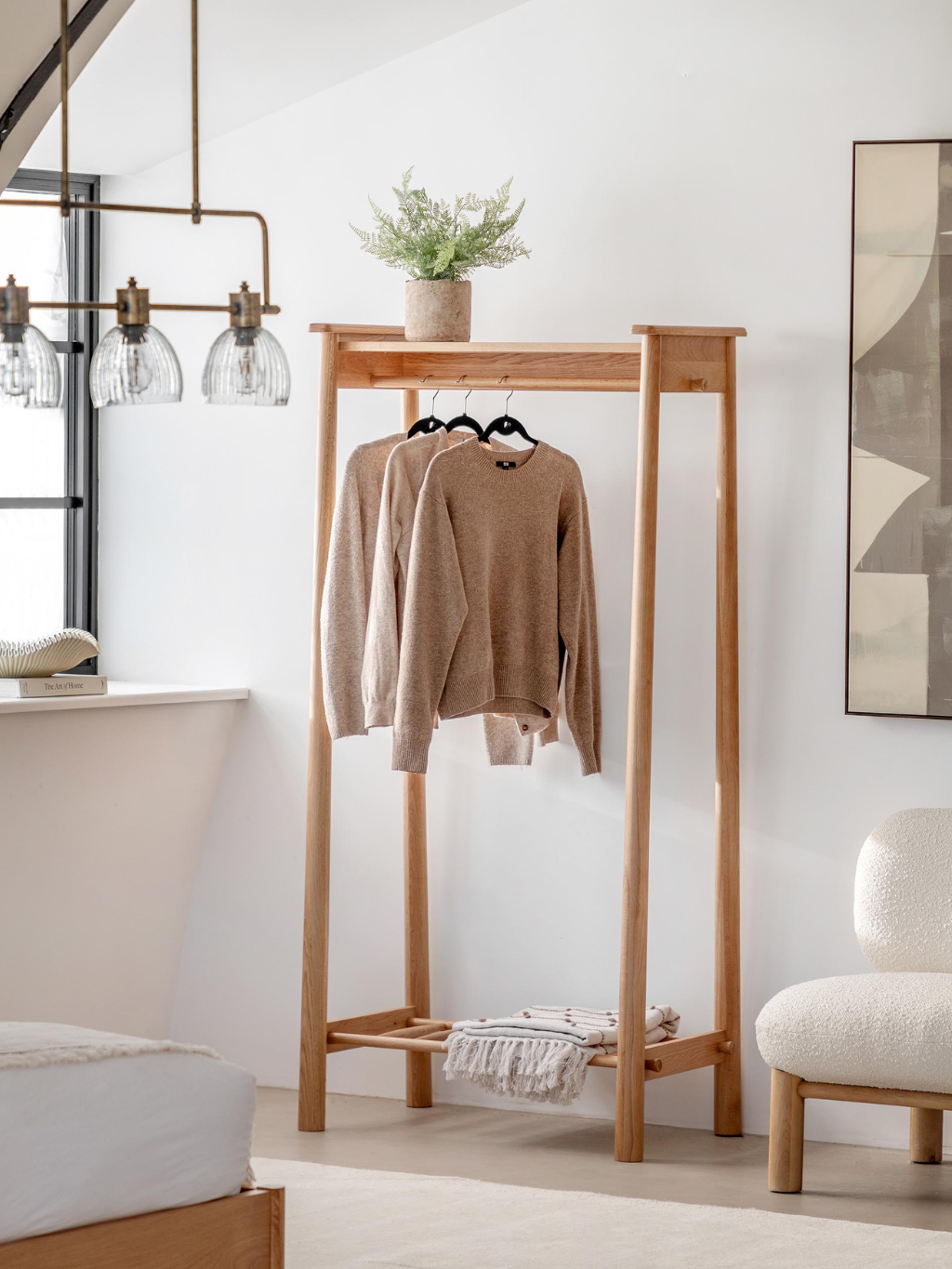 Open wardrobe with clothes hanging on the rail