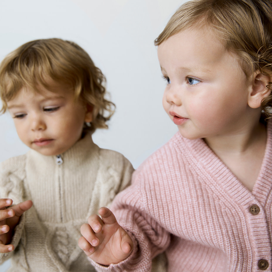 Babies in pink and neutral jumpers