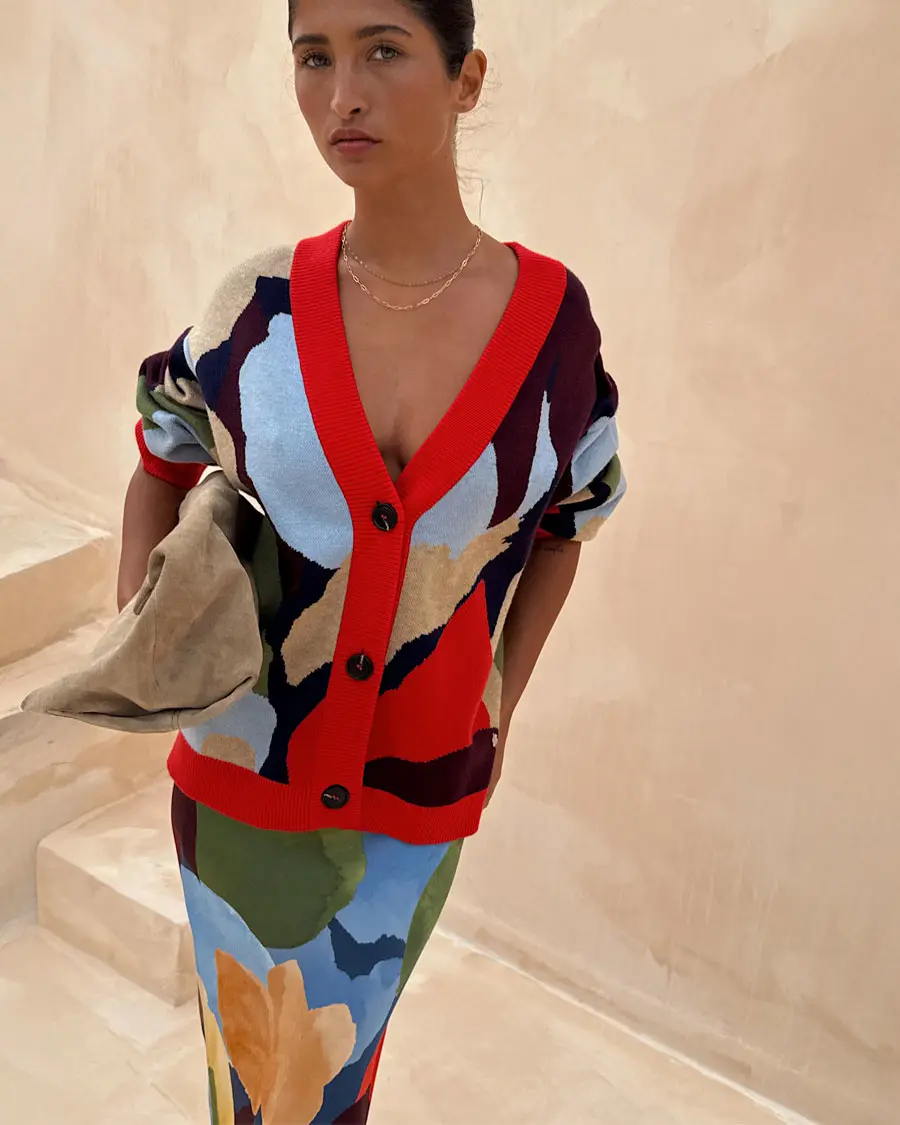 Woman wearing bold patterned cardigan and skirt by Never Fully Dressed