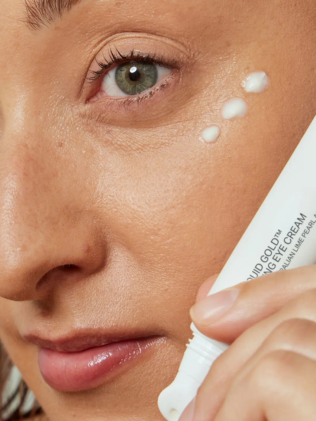 Woman holding an Alpha H eye cream