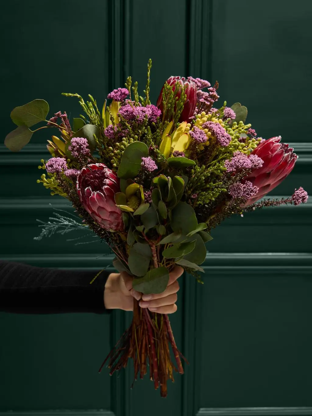 A bouquet of flowers, which include protea