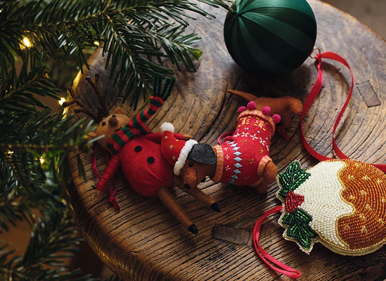 Assorted Christmas baubles on a wooden stool
