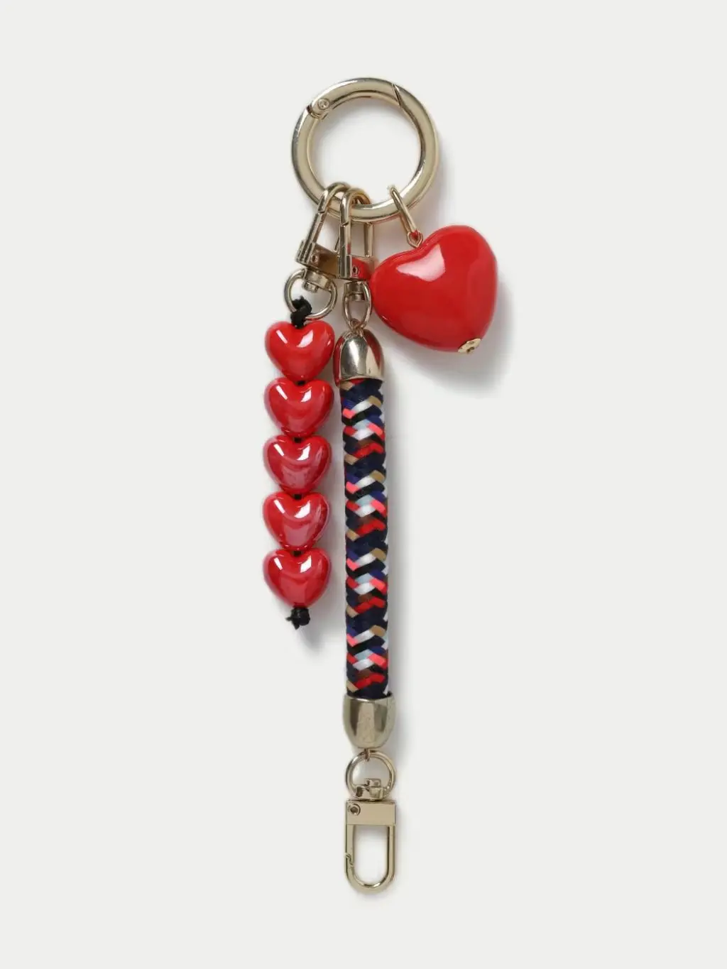 A cut out of a red heart bag charm