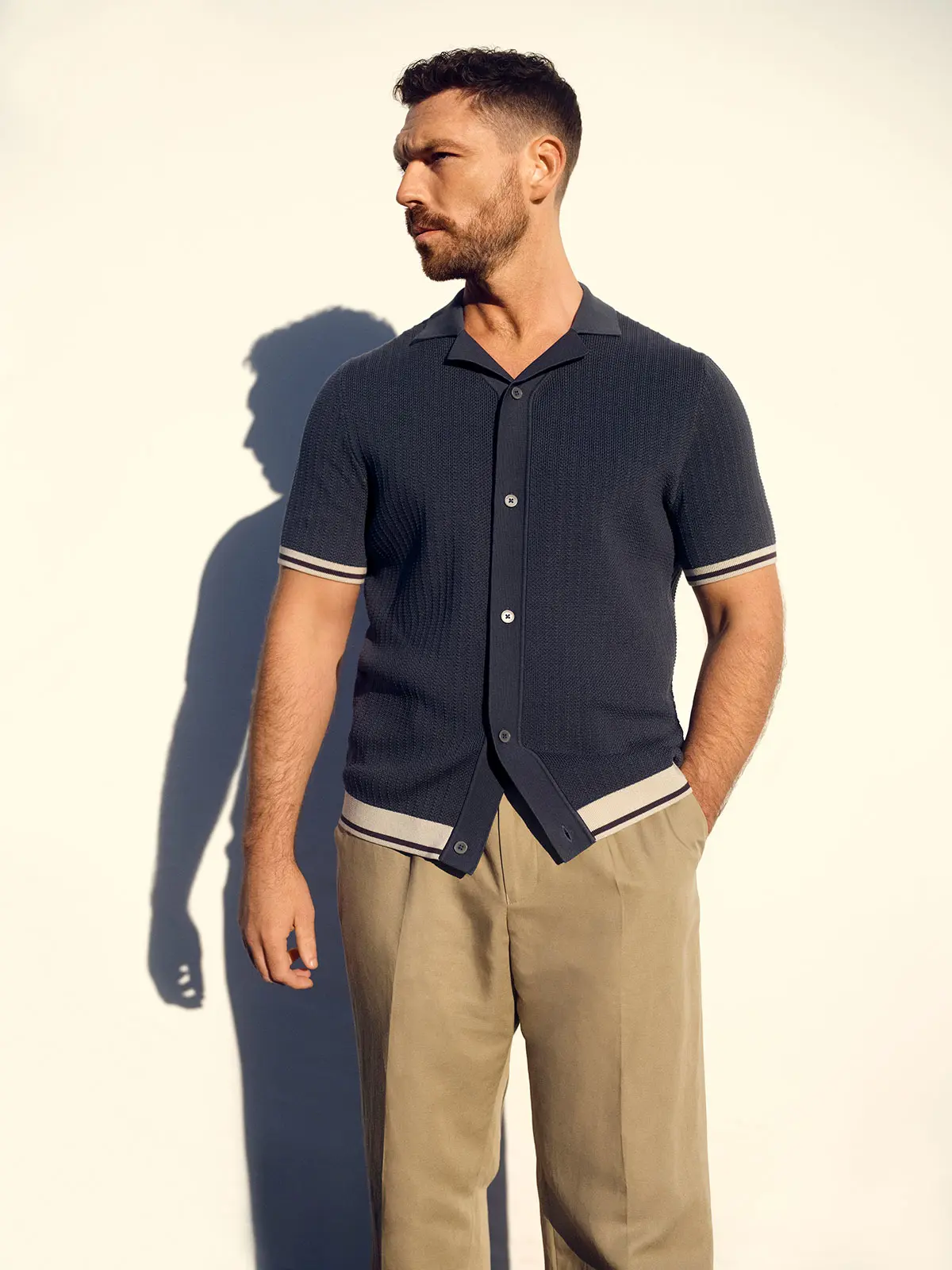 Man wearing chinos and navy polo
