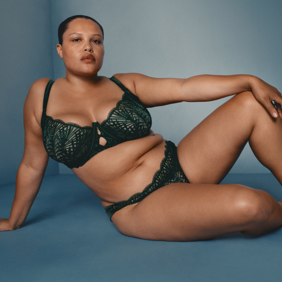 Woman wearing lace lingerie set in forest green