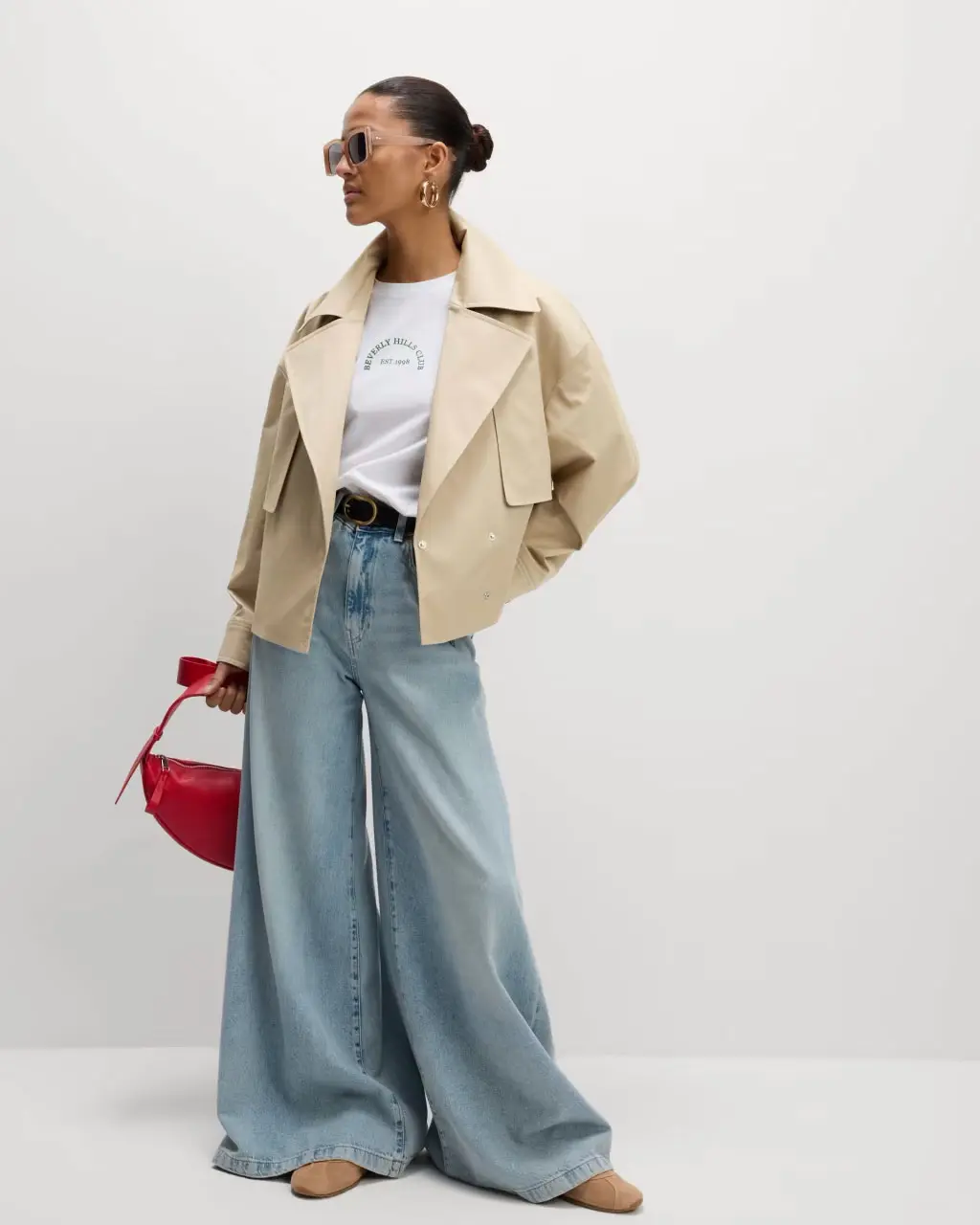Woman wearing cropped trench coat at M&S