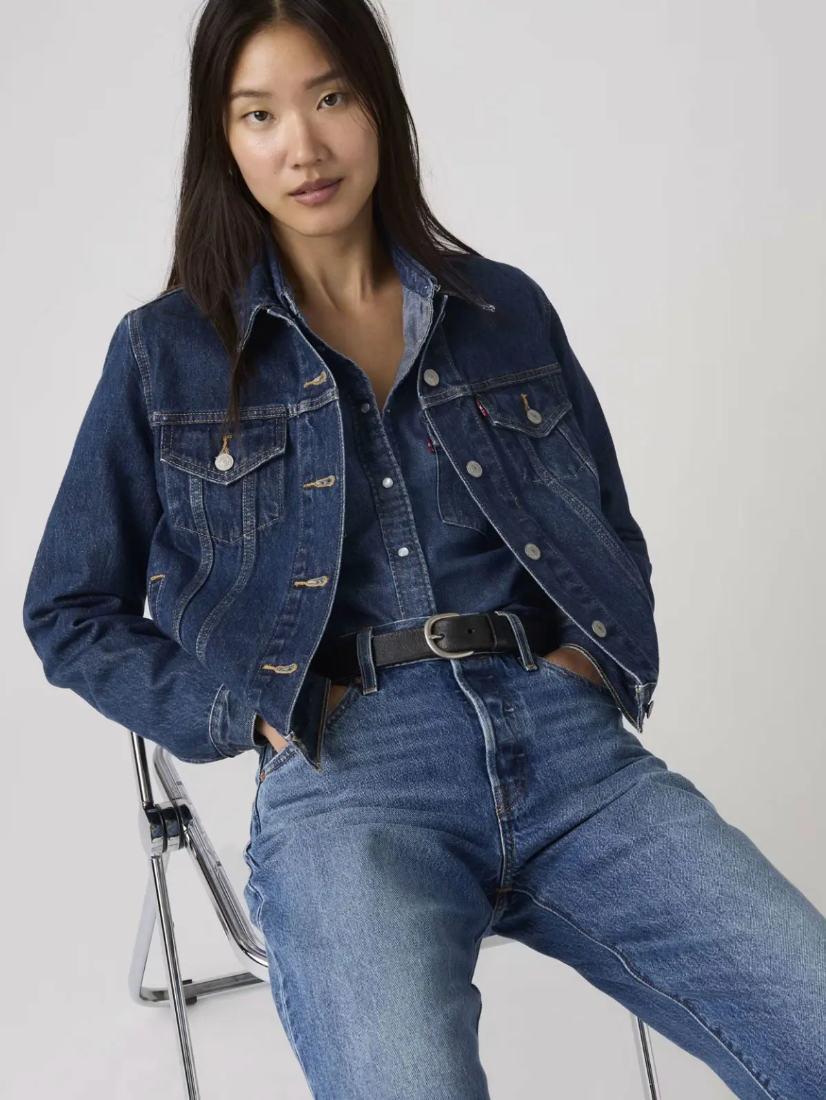 Woman wearing all-denim outfit including jacket, shirt and jeans