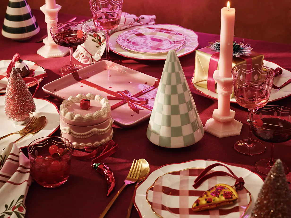 Festive table with candles and seasonal tableware. Christmas hosting at M&S