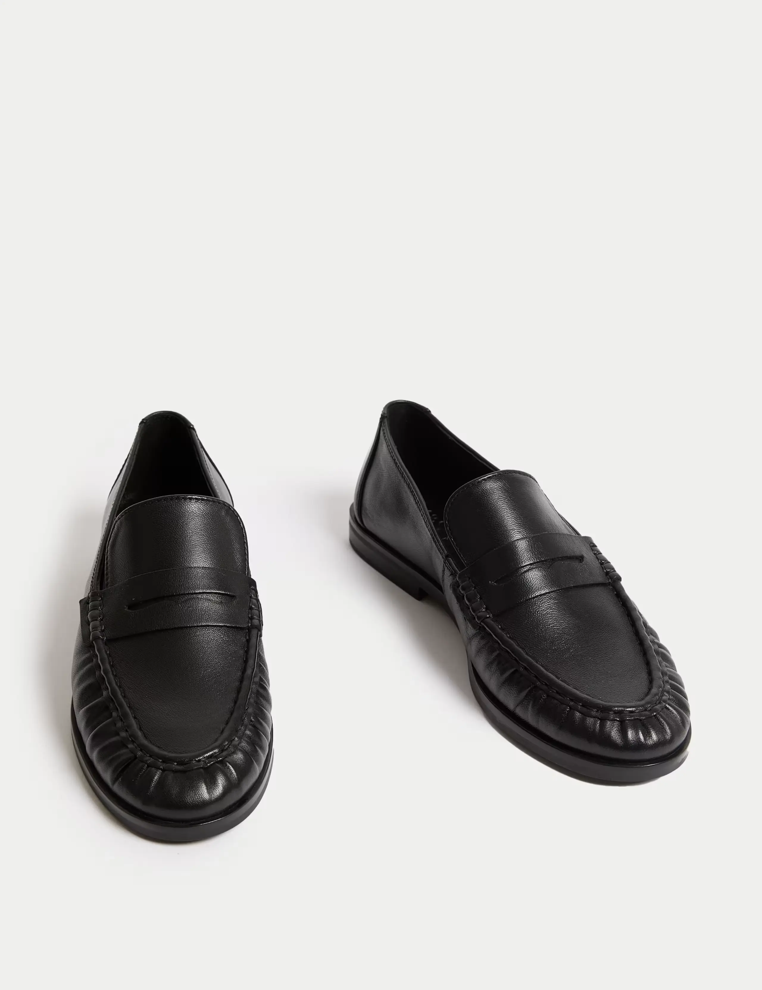 A black pair of leather loafers