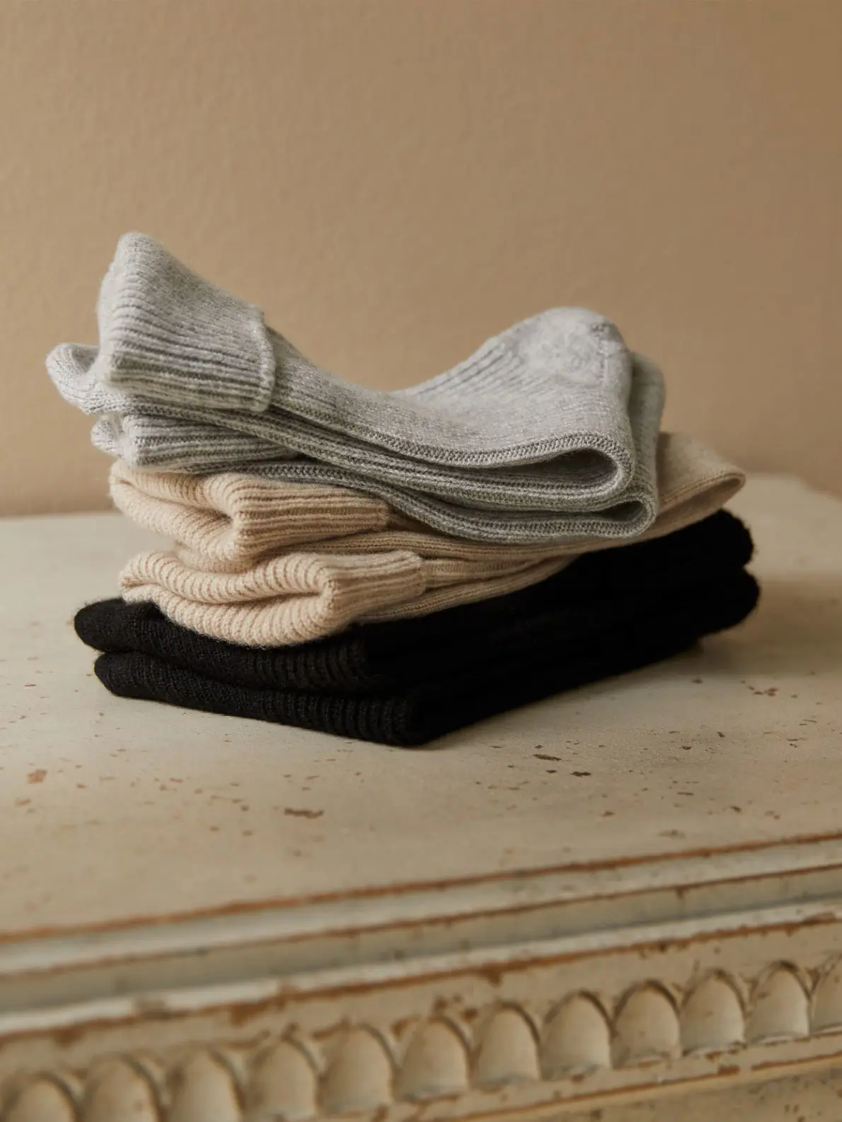 Pile of socks in grey, camel and black 