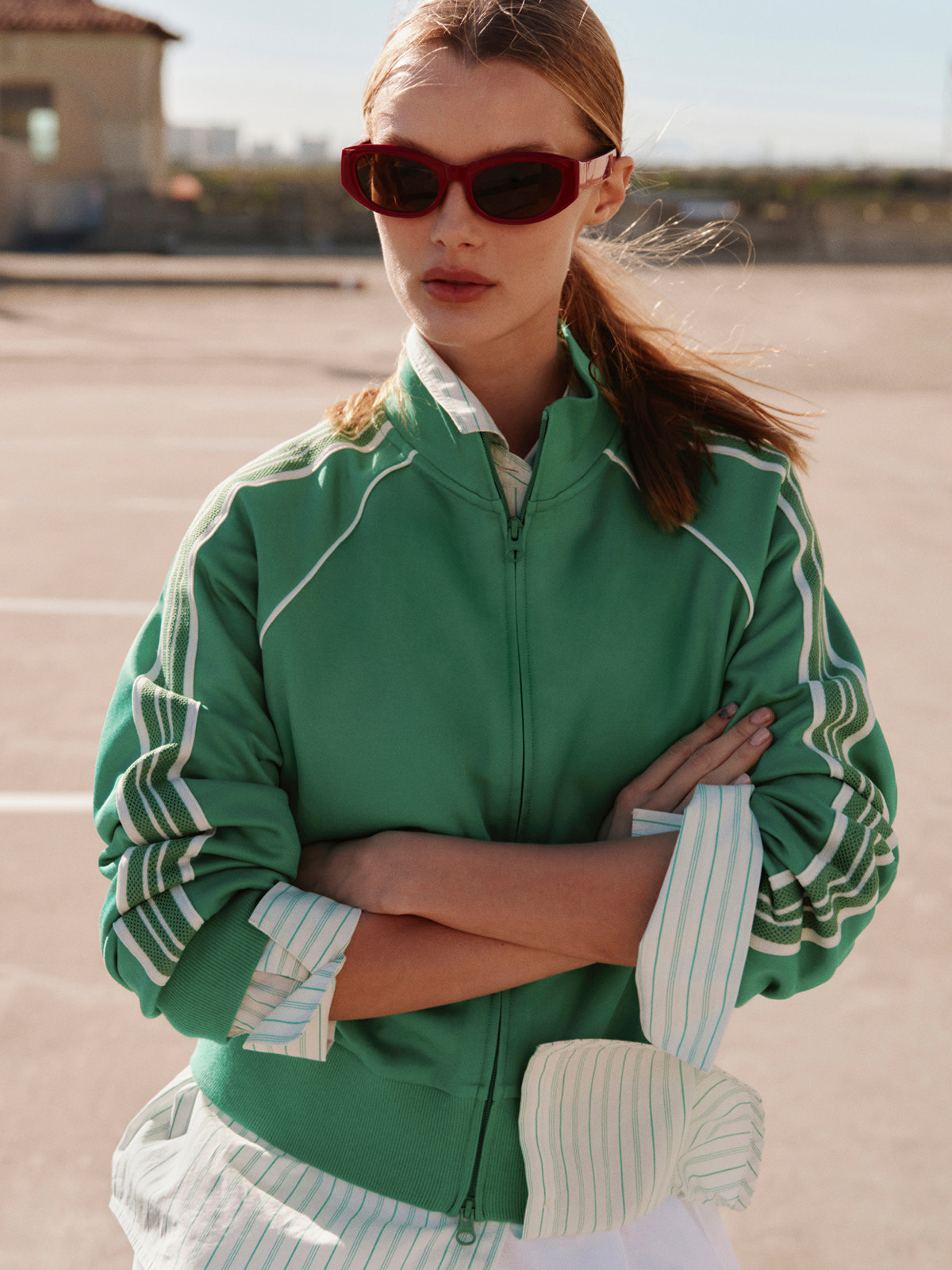 Woman wearing green track jacket 
