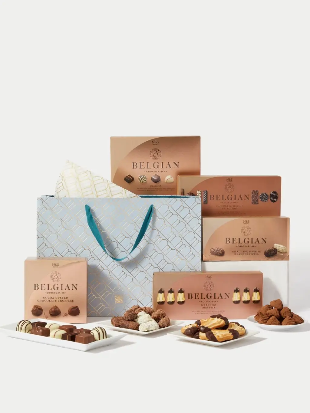 A hamper containing Belgian chocolates and biscuits shot against a light background
