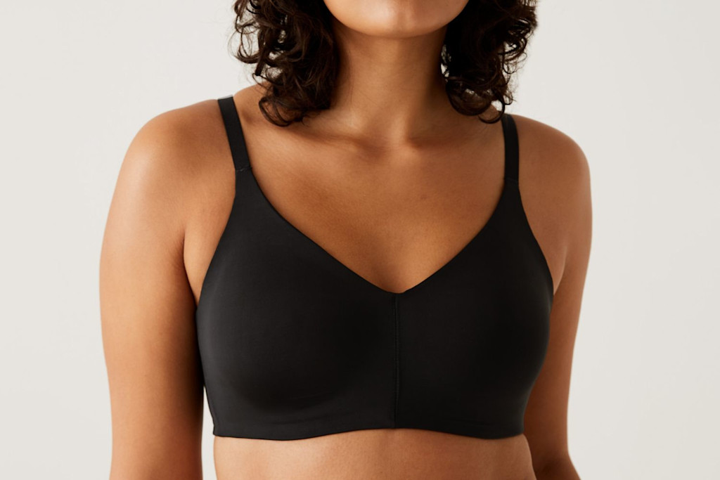 Woman wearing black bra. Shop bras