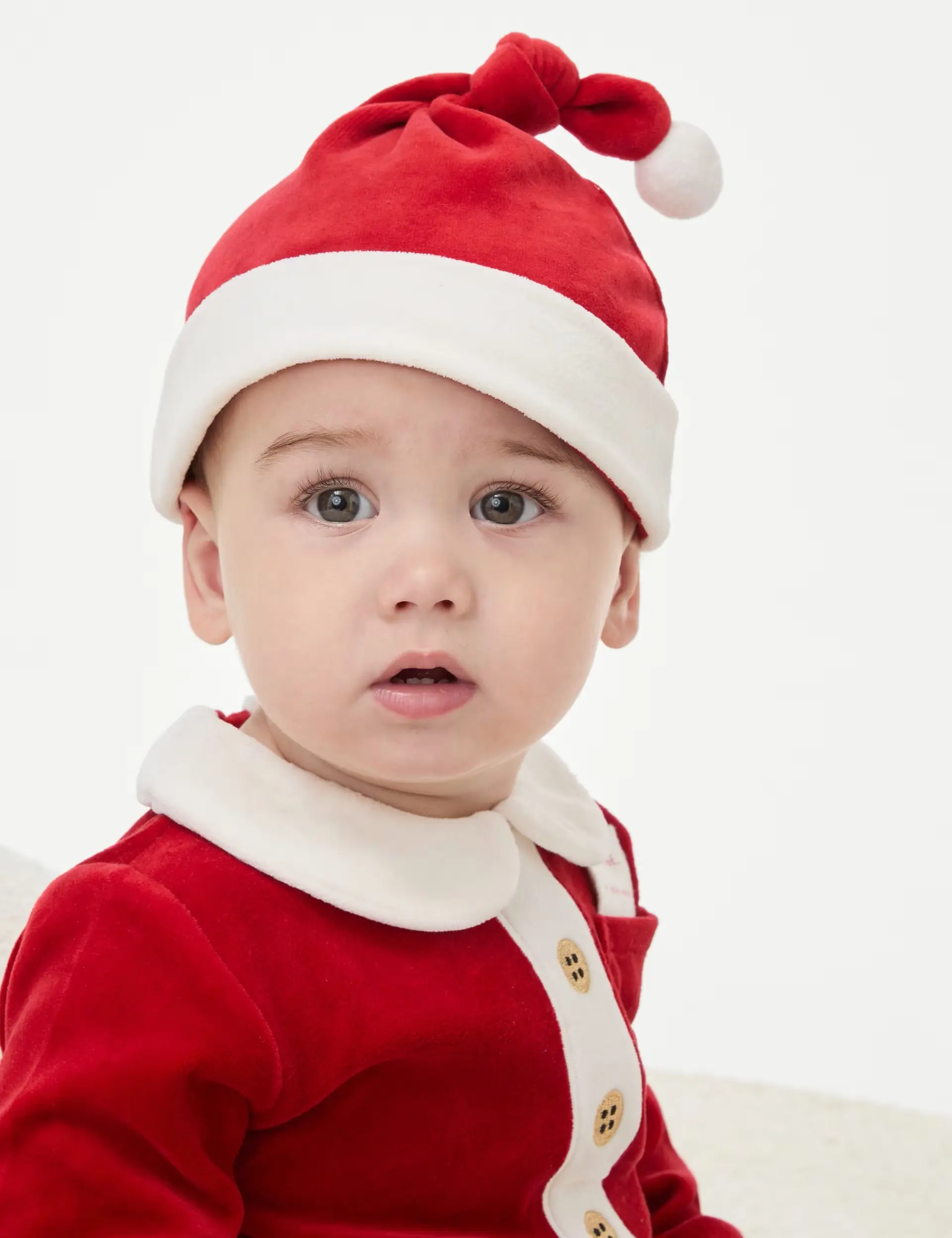 Baby in Christmas Santa outfit with hat