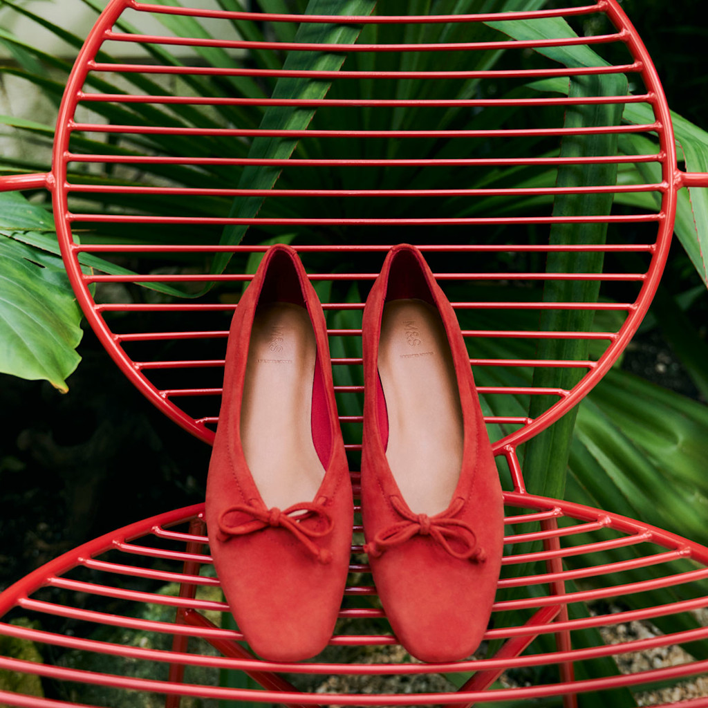 A pair of red shoes on a chair