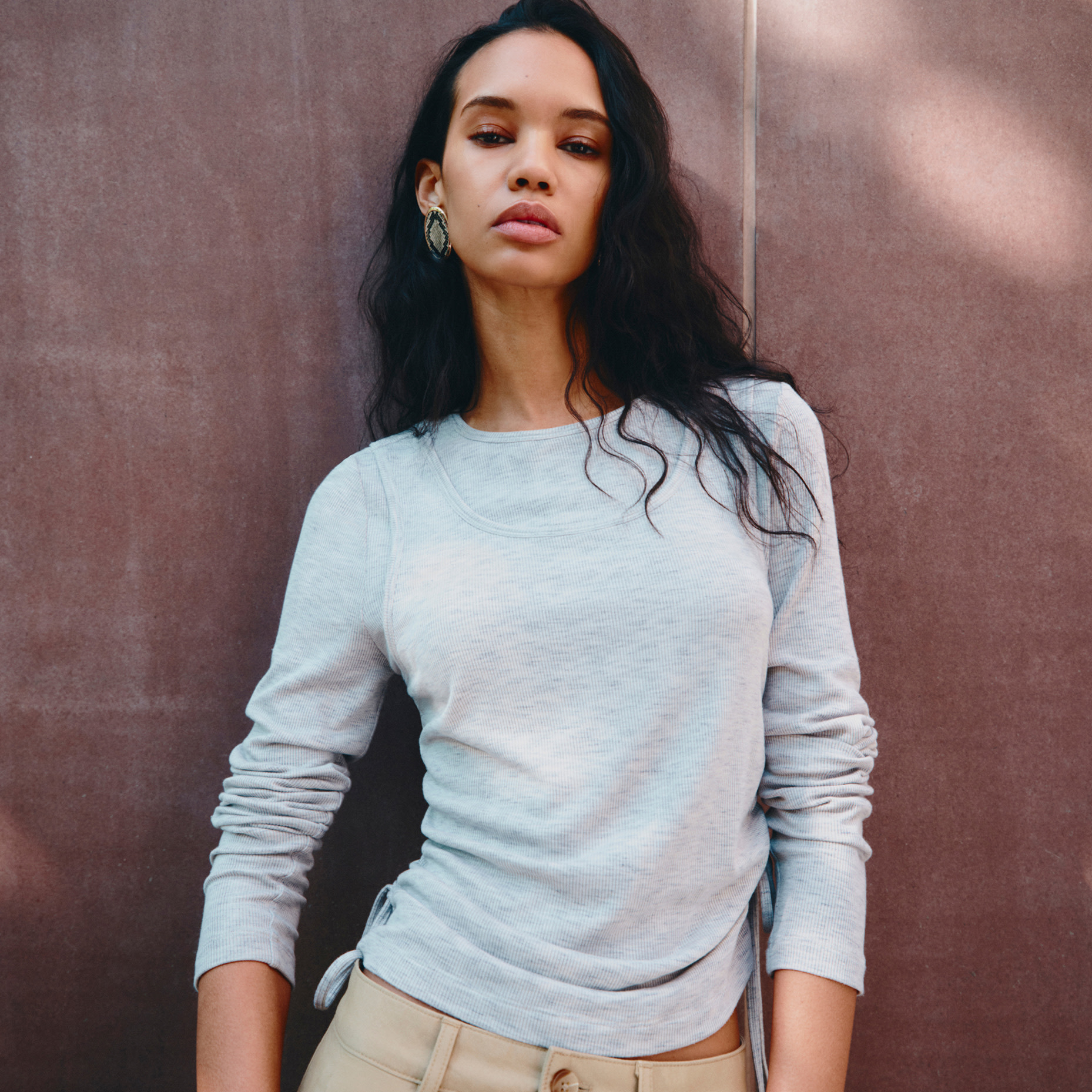 Woman wearing grey long-sleeve top