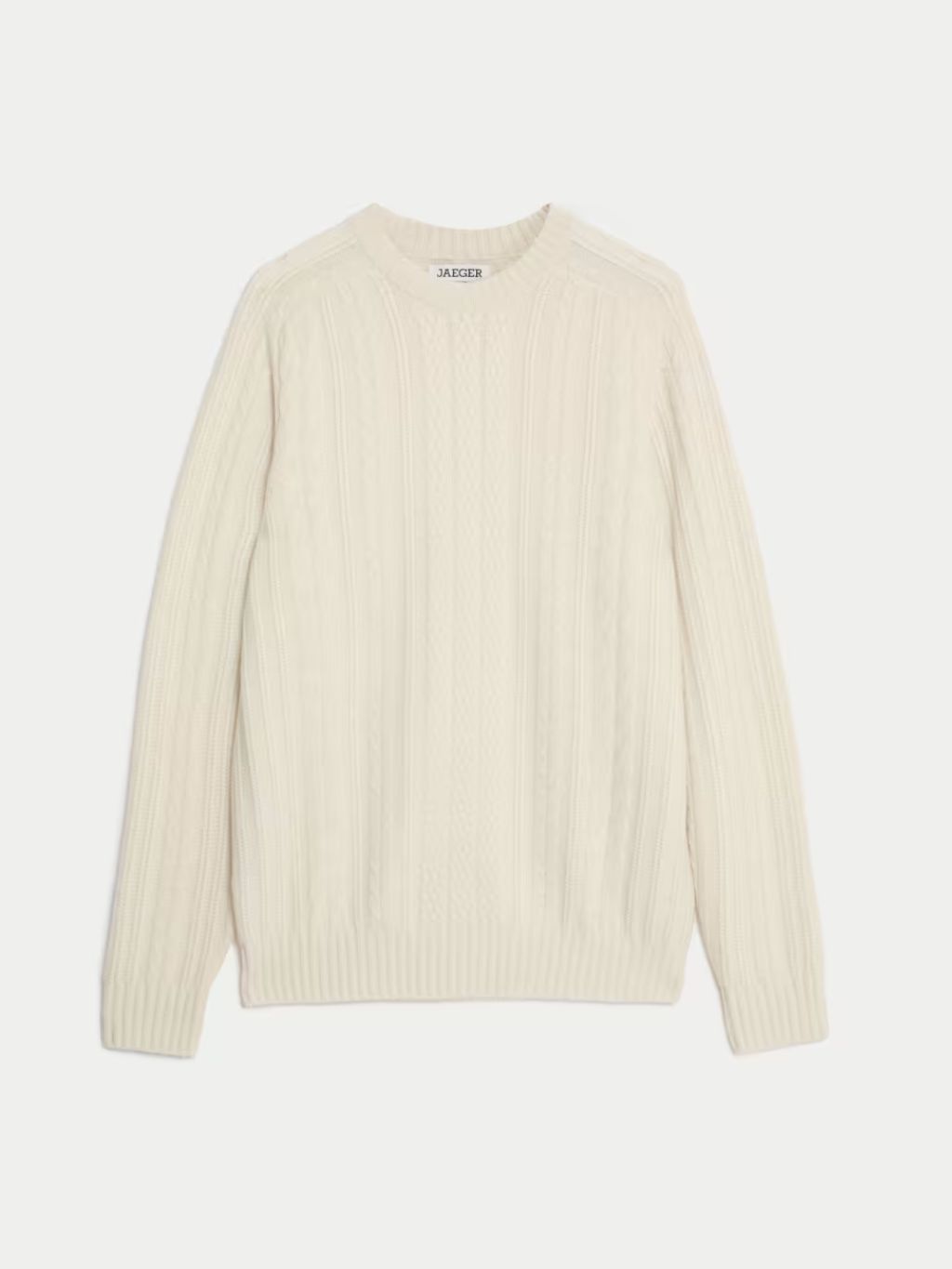 A cut out of a cream cable knit cashmere jumper against a light background