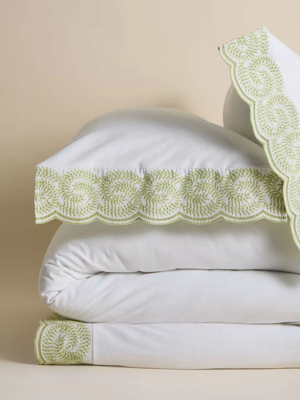 White bedding with green embroidered edge