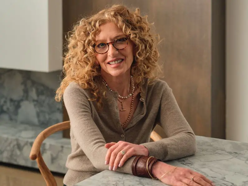 Kelly Hoppen sits at a table