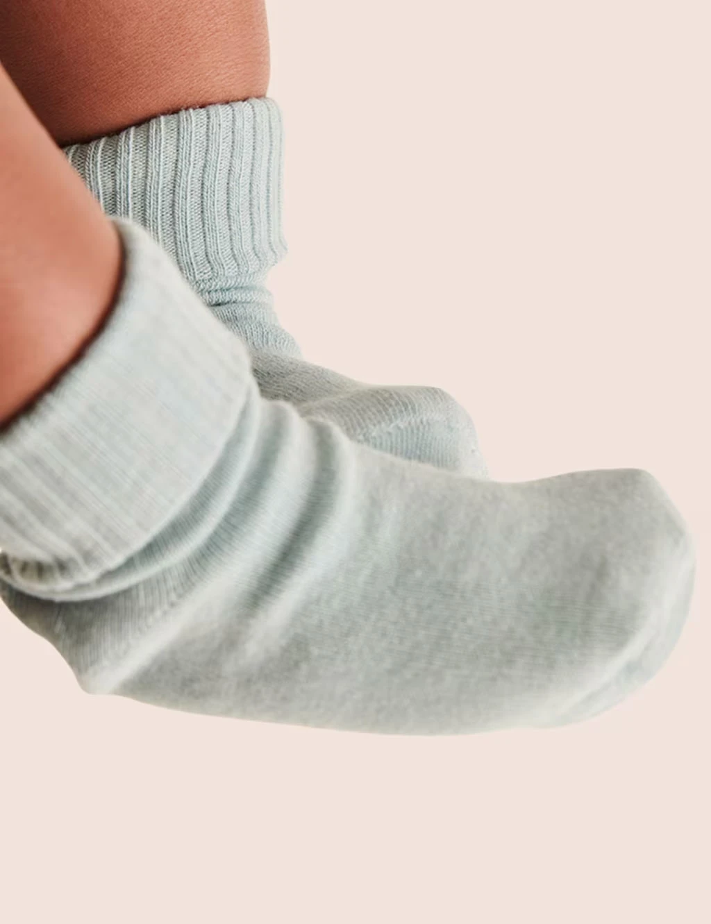 Baby wearing light blue socks