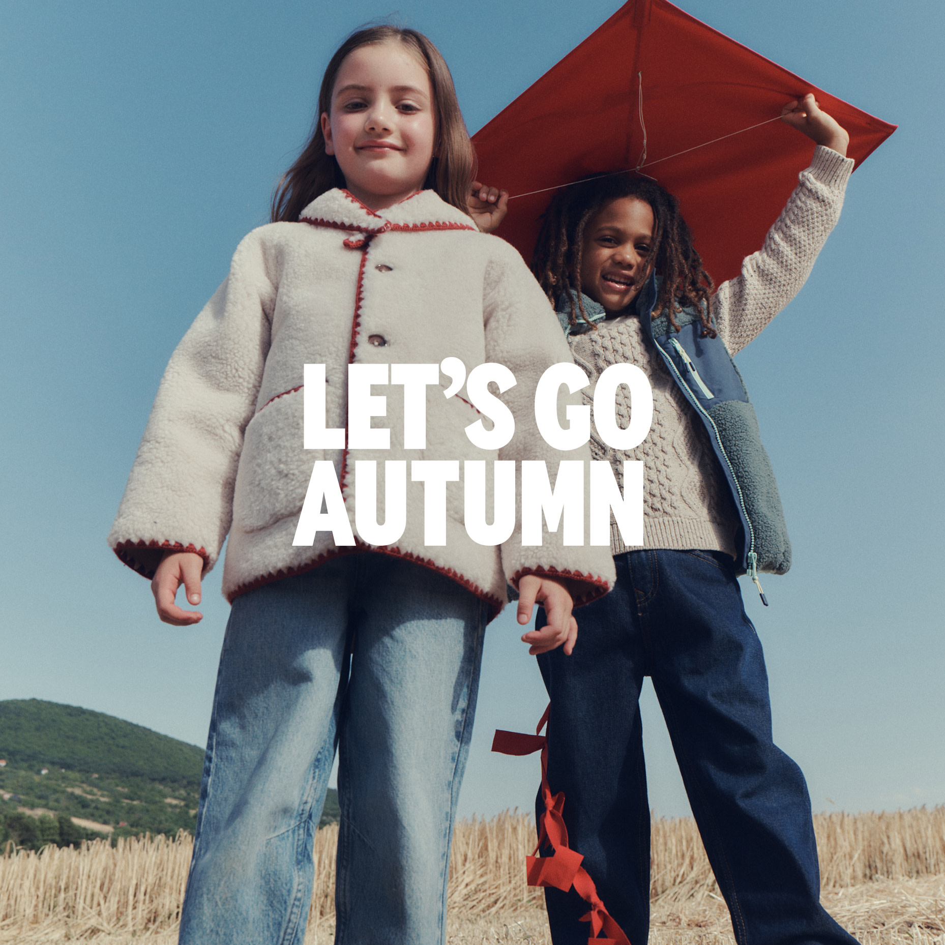 Two children wearing autumn clothing