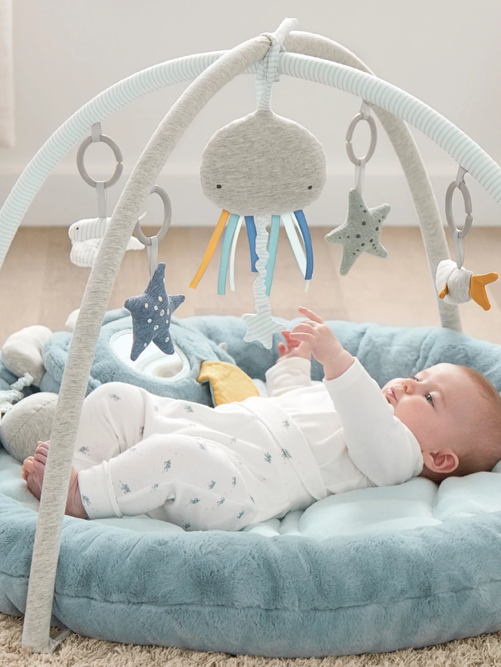 Baby on playmat christening gift