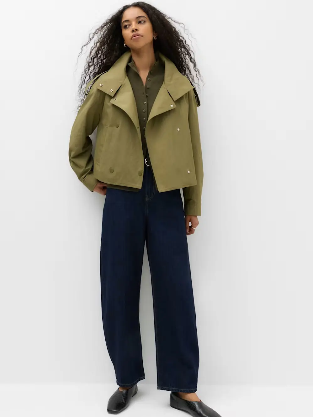 Woman in green jacket and jeans