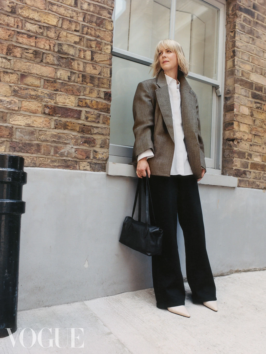 British Vogue editor Laura Ingham wearing a brown blazer, white shirt and dark-blue wide-leg jeans by Autograph