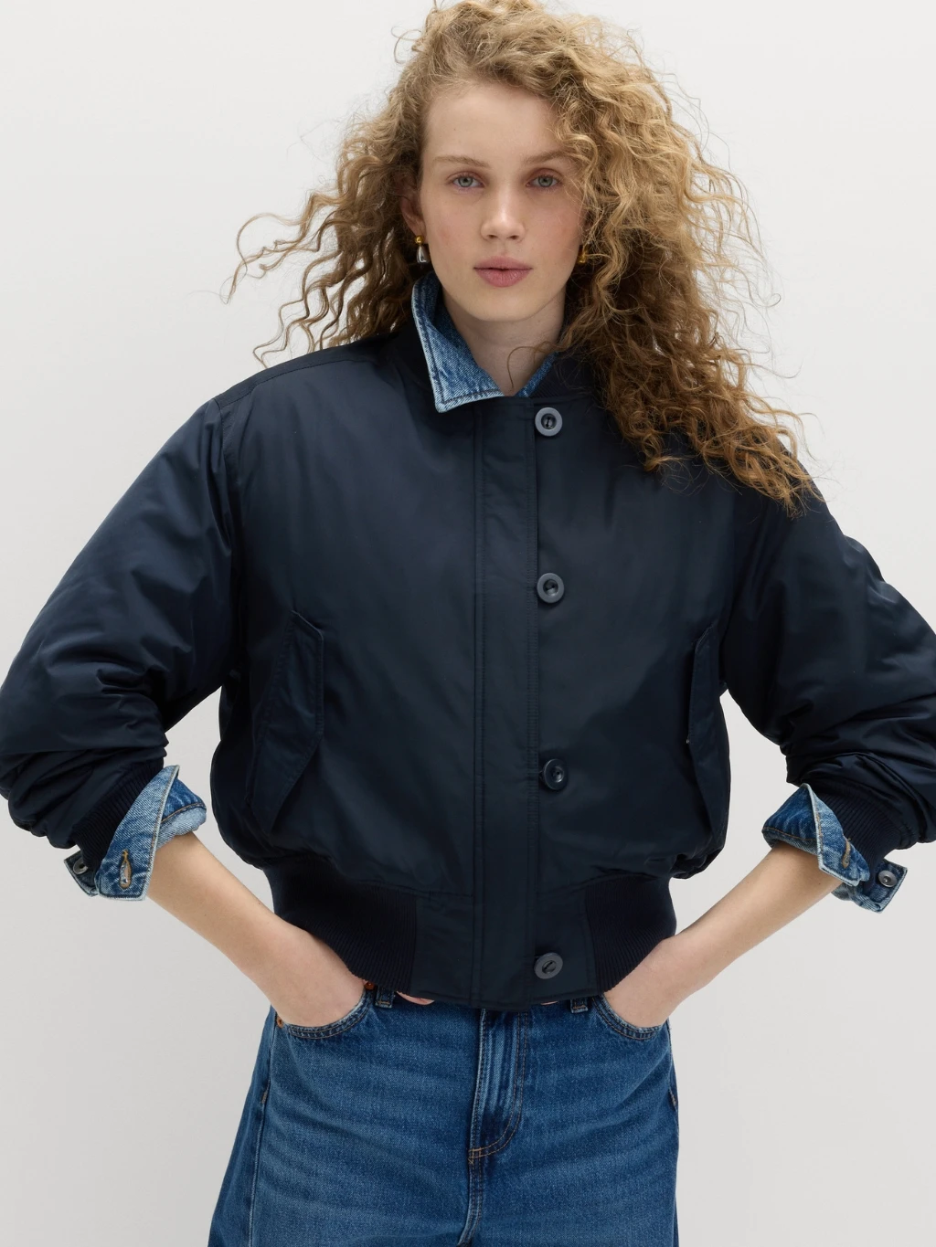 Woman wearing navy bomber flight jacket