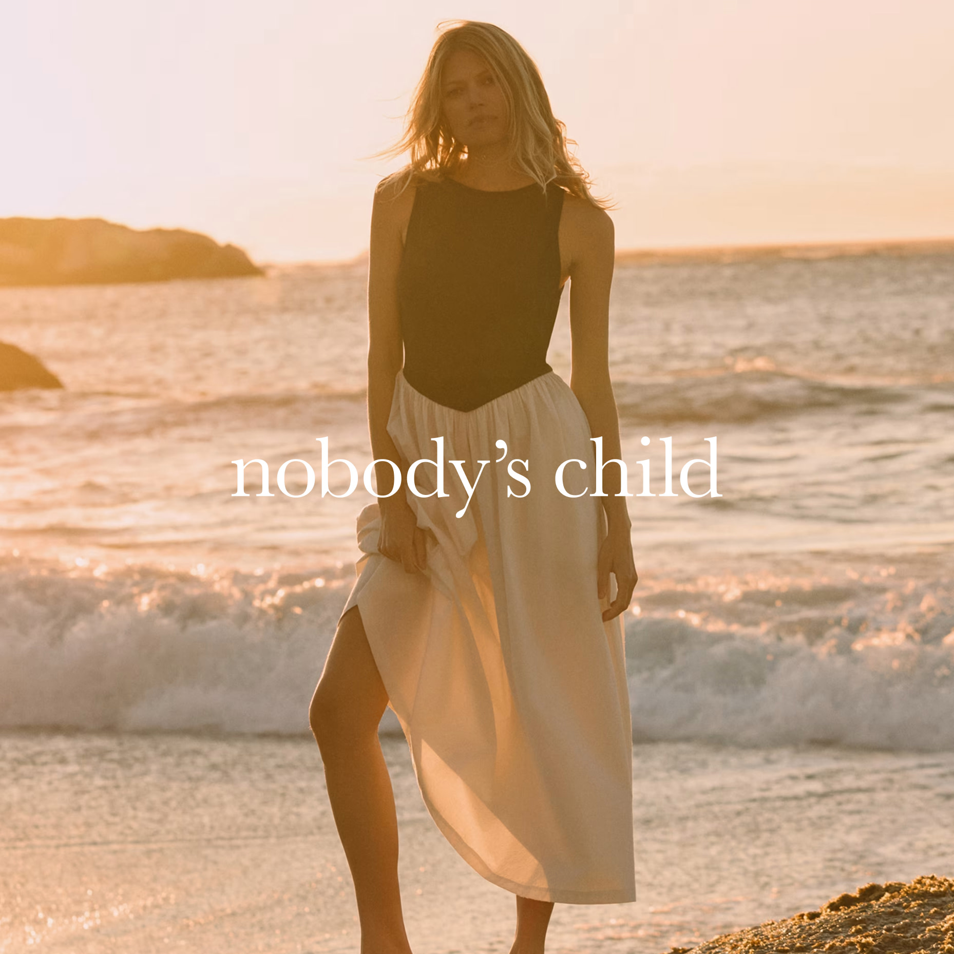 Woman wearing a black and white Nobody's Child dress
