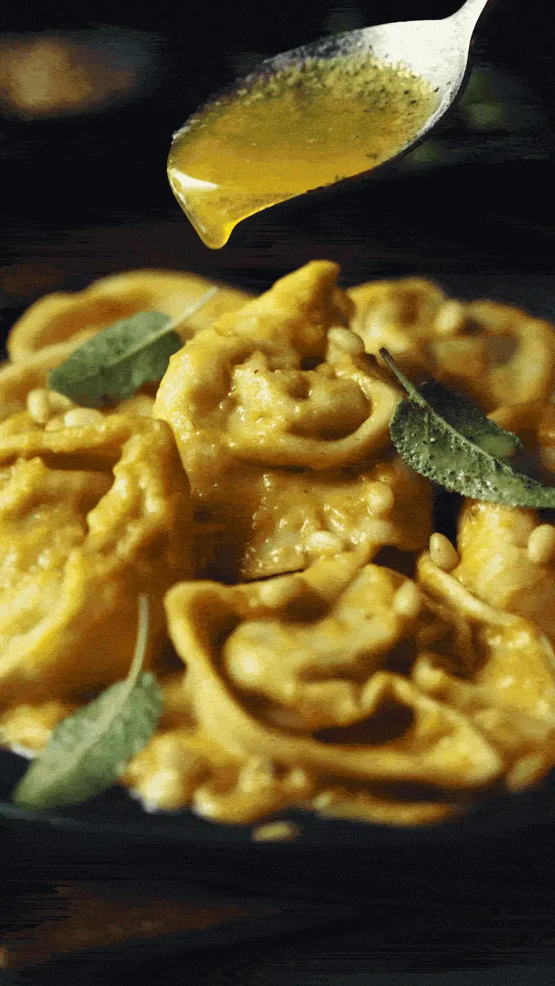 Butter being poured onto tortellini