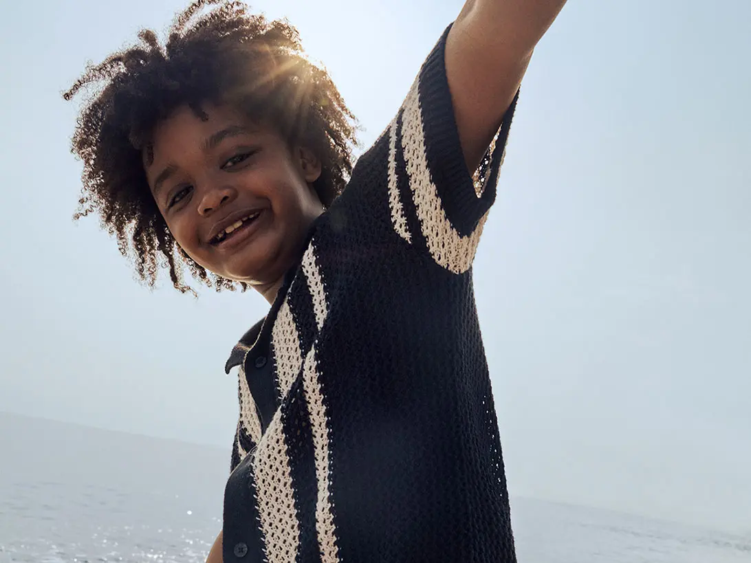 Boy wearing crochet-style shirt